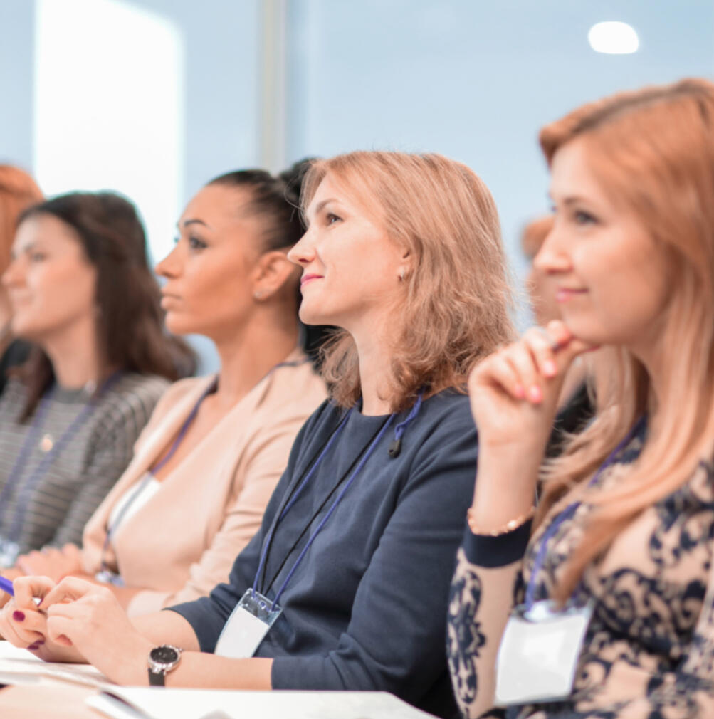 women seated at a conference